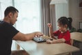 Education studying concept. Little cute asian baby girl children playing chess with her father dad in the living room at home. Royalty Free Stock Photo