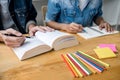 Education, teaching, learning concept. High school students or classmates group tutor in library studying and reading with helps Royalty Free Stock Photo