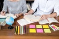 Education, teaching, learning concept. Two high school students or classmates group sitting in library with helps friend doing Royalty Free Stock Photo