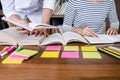 Education, teaching, learning concept. Two high school students or classmates group sitting in library with helps friend doing Royalty Free Stock Photo