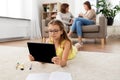 Girl with tablet computer lying on floor at home