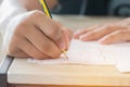 Education test concept : Man Hands high school, university student holding pencil for testing exams writing answer sheet and Royalty Free Stock Photo