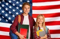 Education In USA. Happy kids with backpacks posing over American flag background Royalty Free Stock Photo