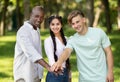 Education and unity concept. Happy international students stacking hands together, walking in college campus Royalty Free Stock Photo