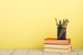 education and wisdom concept - books on wooden table, color background Royalty Free Stock Photo