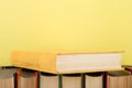 education and wisdom concept -books on wooden table, color background Royalty Free Stock Photo