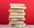 education and wisdom concept - books on wooden table, color background Royalty Free Stock Photo