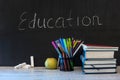 Education word on chalkboard with school books on desk, education concept Royalty Free Stock Photo