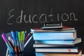 Education word on chalkboard with school books on desk, education concept