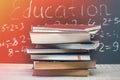 Education word on chalkboard with school books on desk, education concept Royalty Free Stock Photo