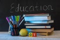 Education word on chalkboard with school books on desk, education concept Royalty Free Stock Photo