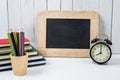 education workspace background concepts alarm clock, Color Pencil in wooden cup and Chalkboard with White wooden vintage wall Royalty Free Stock Photo