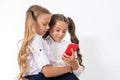 Educational application. Online entertainment concept. Schoolgirls cute pupils use smartphone check social networks