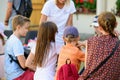 Educational circle for children. Group of nursery children sitting on chairs in their classroom. Male teacher, woman. shows how to