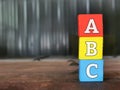 ABC letters alphabet on colorful wooden blocks with blurry background and copy space. Royalty Free Stock Photo