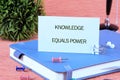 Educational concept highlighting that knowledge equals power in business and finance settings with stationary objects Royalty Free Stock Photo