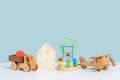 Educational eco-friendly toys for preschool children. Wooden toy car truck, airplane, maze and constructor cubes on a blue Royalty Free Stock Photo