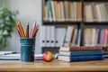 Educational essentials empty desk with school supplies and book stack Royalty Free Stock Photo