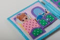 Educational felt book with small wooly details and buttons for little children. Girl and beauty cosmetics. Leisure