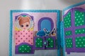 Educational felt book with small wooly details and buttons for little children. Girl and cosmetics.