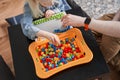 Man and his blonde daughter folding educational game at home