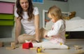 Educational games at home with a child. Building constructor. Happy mom and her daughter. Royalty Free Stock Photo