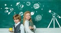 Educational process. Blackboard for your text. Schoolgirl helping pupils studying at desks in classroom. Royalty Free Stock Photo