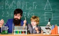 Educational school program. Schoolboy cute child experimenting with liquids. Perseverance pays off. Teacher and child