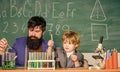 Educational school program. Schoolboy cute child experimenting with liquids. Perseverance pays off. Teacher and child