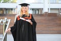 Educational theme: graduating student girl in an academic gown. Royalty Free Stock Photo