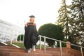 Educational theme: graduating student girl in an academic gown. Royalty Free Stock Photo