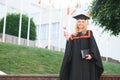 Educational theme: graduating student girl in an academic gown. Royalty Free Stock Photo