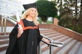 Educational theme: graduating student girl in an academic gown. Royalty Free Stock Photo