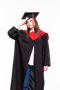 Graduating student girl in an academic gown isolated over white background Royalty Free Stock Photo