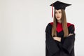 Educational theme: graduating student girl in an academic gown isolated over white background Royalty Free Stock Photo