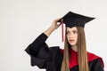 Educational theme: graduating student girl in an academic gown isolated over white background Royalty Free Stock Photo