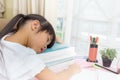 Educational theme: schoolgirl sleeping on her textbooks in home Royalty Free Stock Photo