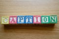 Educational toy cubes with letters organised to display word CAPTION - editing metadata and Search engine optimisation Royalty Free Stock Photo