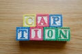 Educational toy cubes with letters organised to display word CAPTION - editing metadata and Search engine optimisation Royalty Free Stock Photo