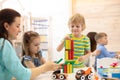 Educational toys for preschool and kindergarten children. Cute little kids playing with blocks in day care center.