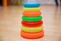 Educational toys for toddlers, gripping rings, isolated on yellow. Colorful Pyramid of Stacked Circular Blocks . Pyramid build fro Royalty Free Stock Photo