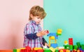 Educational toys for young children. Little boy playing with lots of colorful plastic blocks constructor. Boy playing Royalty Free Stock Photo