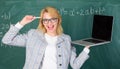 Educator cheerful lady with modern laptop surfing internet chalkboard background. Education is fun. Digital technologies