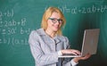 Educator smart clever lady with modern laptop searching information chalkboard background. Learn it easy way. Digital