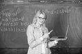 Educator smart lady with modern laptop surfing internet chalkboard background. Basic school education. Woman teacher