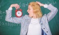 Educator start lesson. She care about discipline. Woman teacher hold alarm clock. Lessons schedule concept. Time for