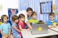 Educator Surrounded by Kids at Kindergarten