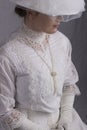 Edwardian woman in white blouse and skirt sitting on a chair Royalty Free Stock Photo