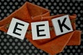 Eek Halloween phrase letters on orange fabric with fun black pol Royalty Free Stock Photo