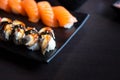 Eel and salmon sushi sashimi on black dish with empty table Royalty Free Stock Photo